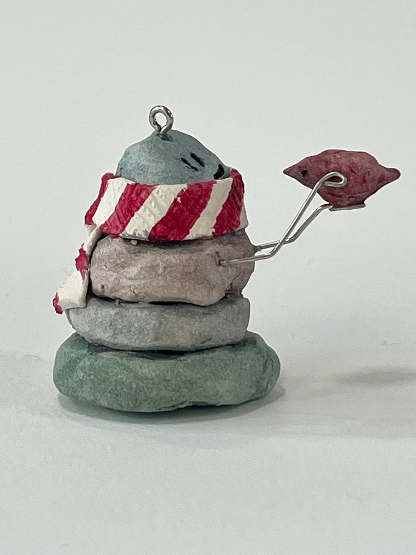 Curious Cairn-red bird in hand