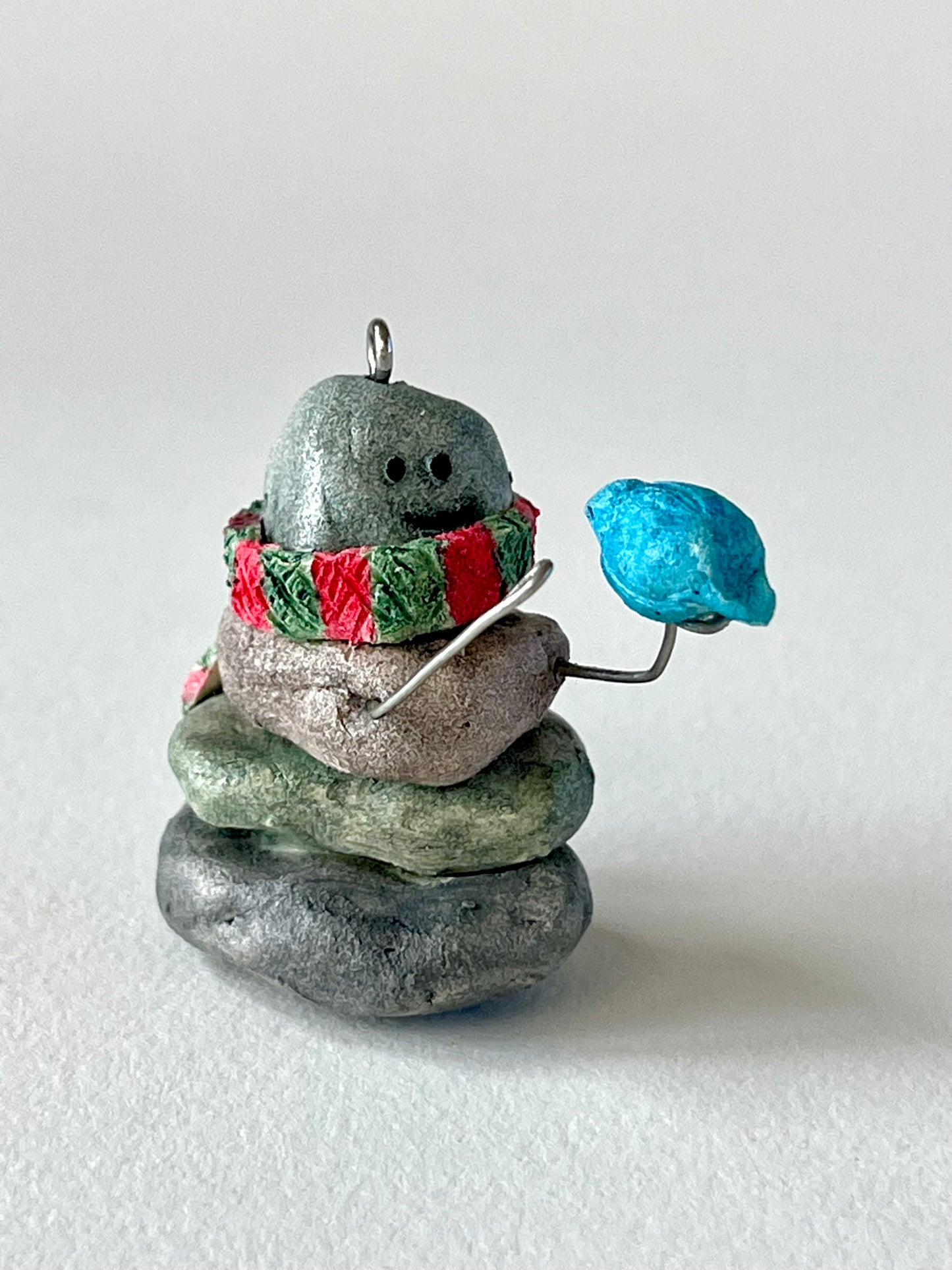 Curious Cairn-blue bird on hand