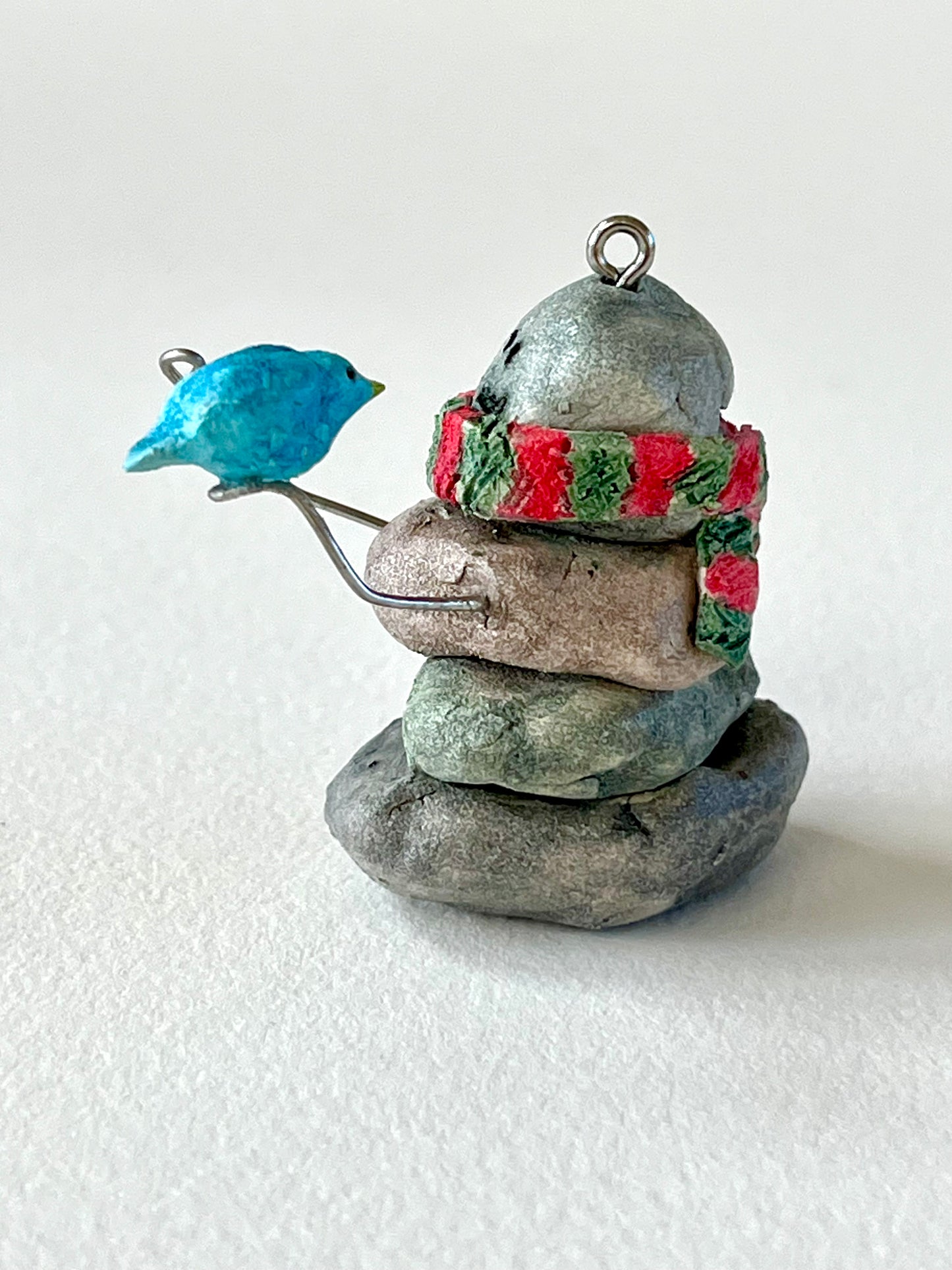 Curious Cairn-blue bird on hand