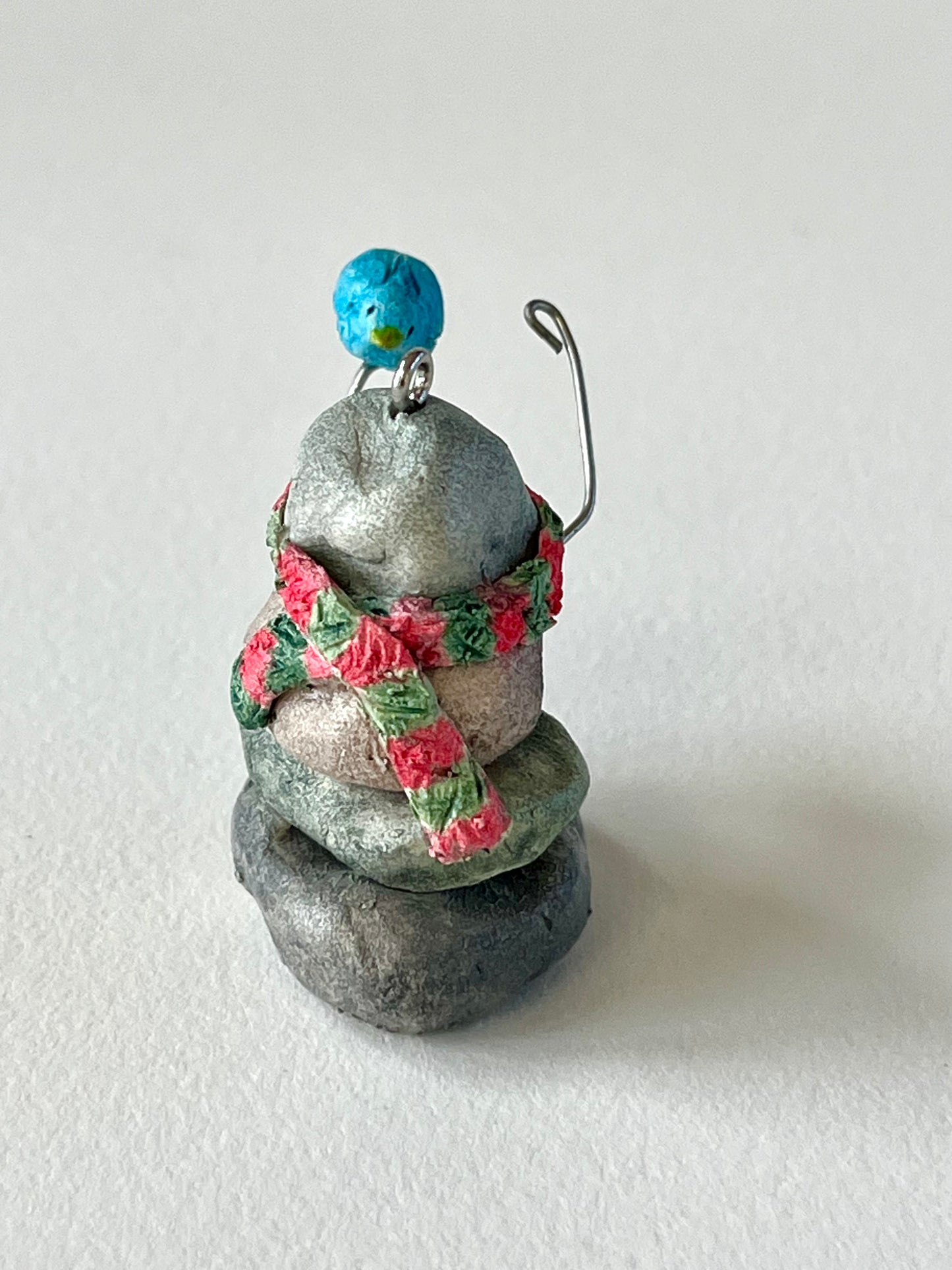 Curious Cairn-blue bird on hand