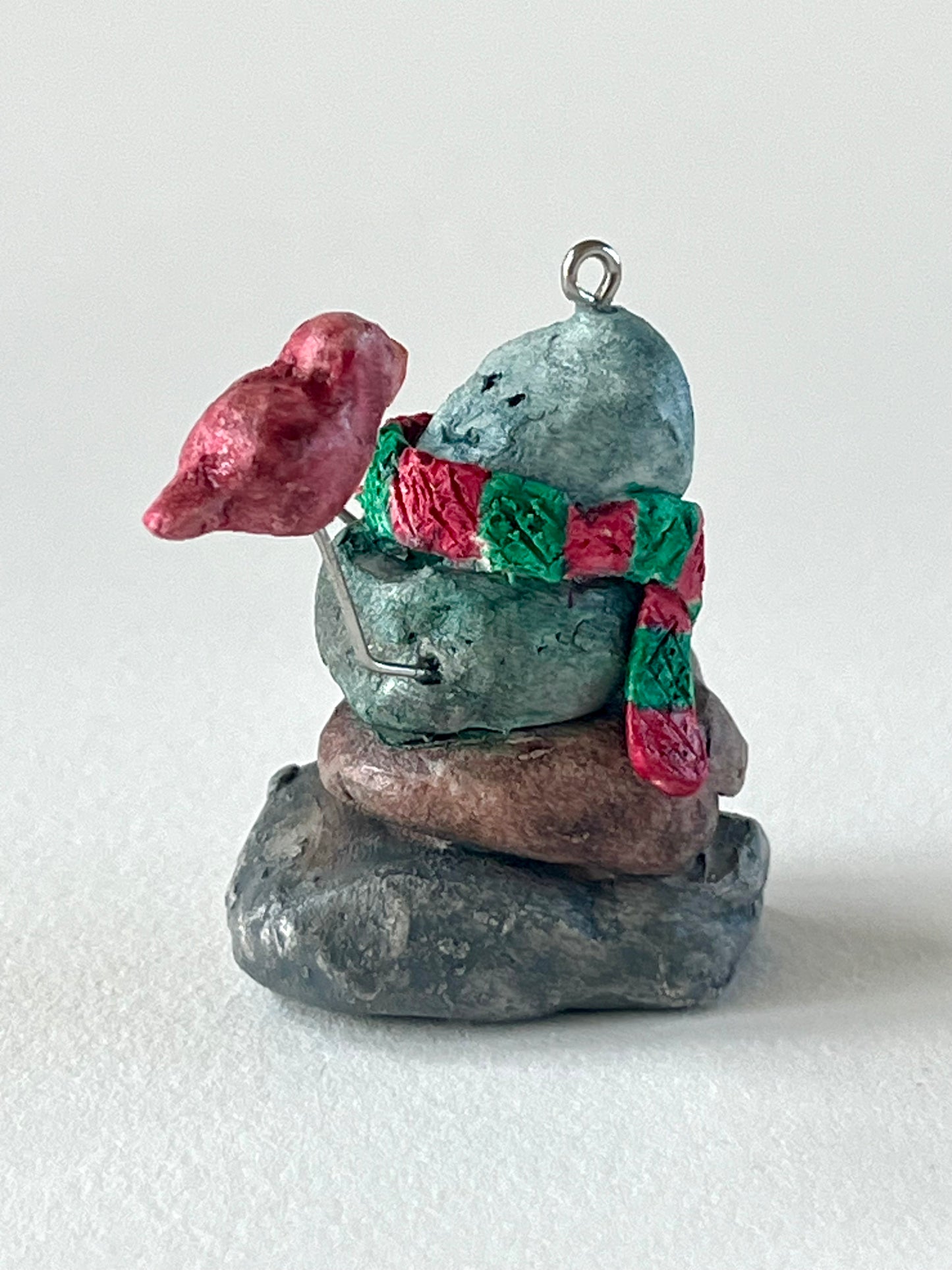 Curious Cairn-red bird on hand