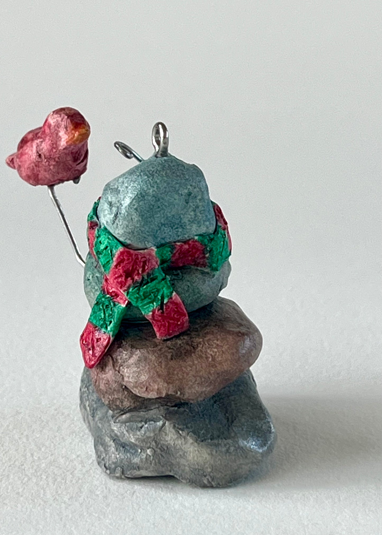 Curious Cairn-red bird on hand