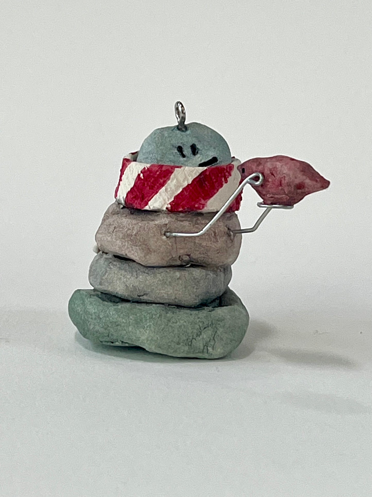 Curious Cairn-red bird in hand