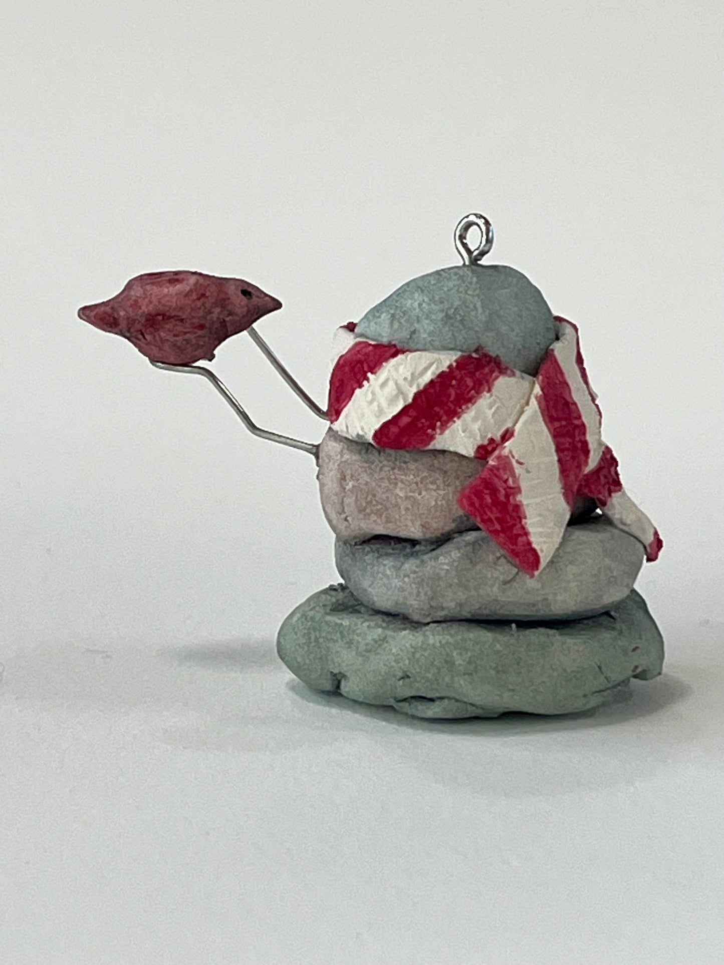 Curious Cairn-red bird in hand