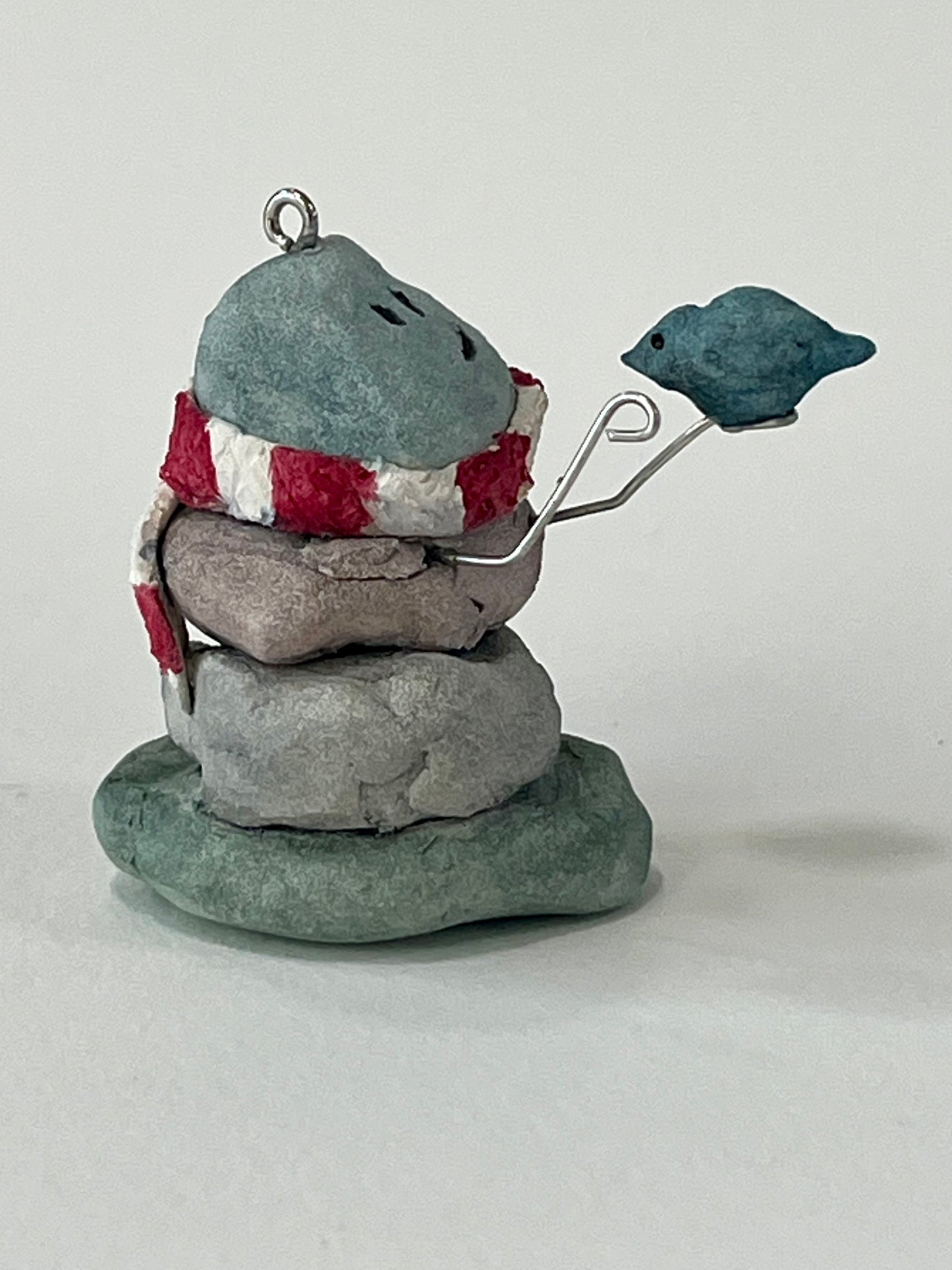 Curious Cairn-blue bird in hand